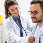 Cardiologist checking a patients heart beat