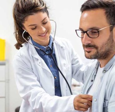 Cardiologist checking a patients heart beat