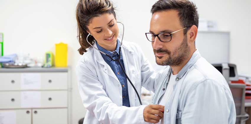 Cardiologist checking a patients heart beat